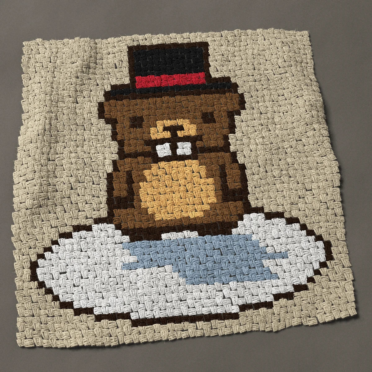 A baby blanket worked corner to corner, 35¼ by 36¾ inches: Groundhog Day groundhog in a top hat with its shadow, 47 by 49 blocks