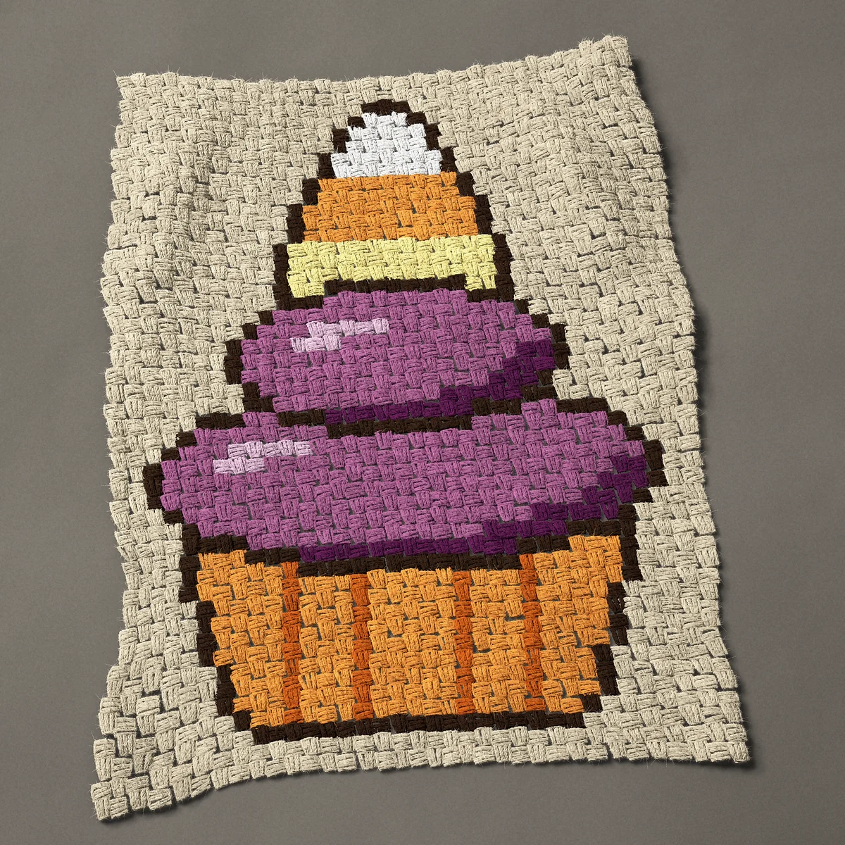 A panel worked corner to corner, 26¼ by 36 inches: Halloween cupcake with a candy corn on top, 35 by 48 blocks