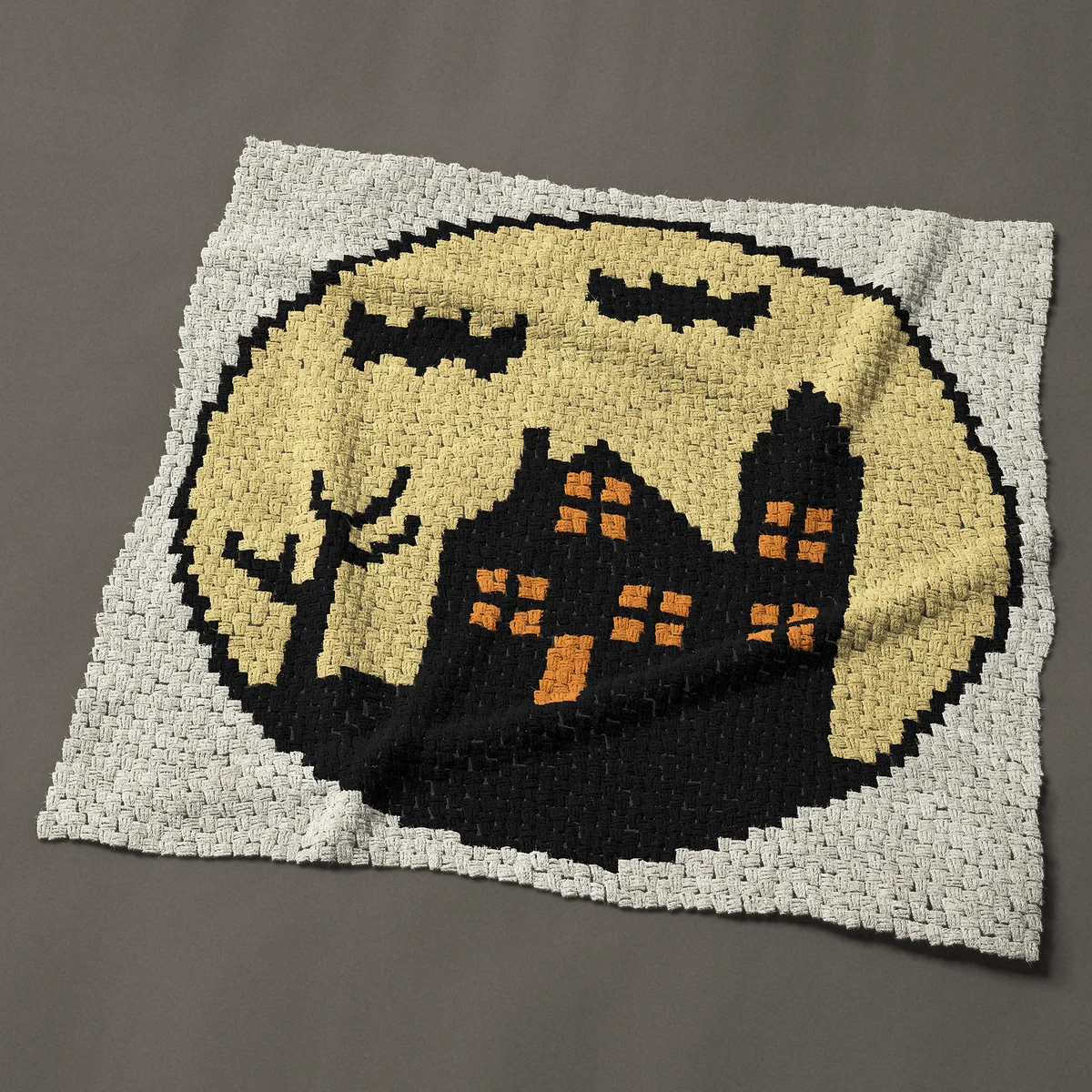 A throw worked corner to corner, 50 by 50 inches: Halloween haunted house with bats and a full moon, 67 by 67 blocks
