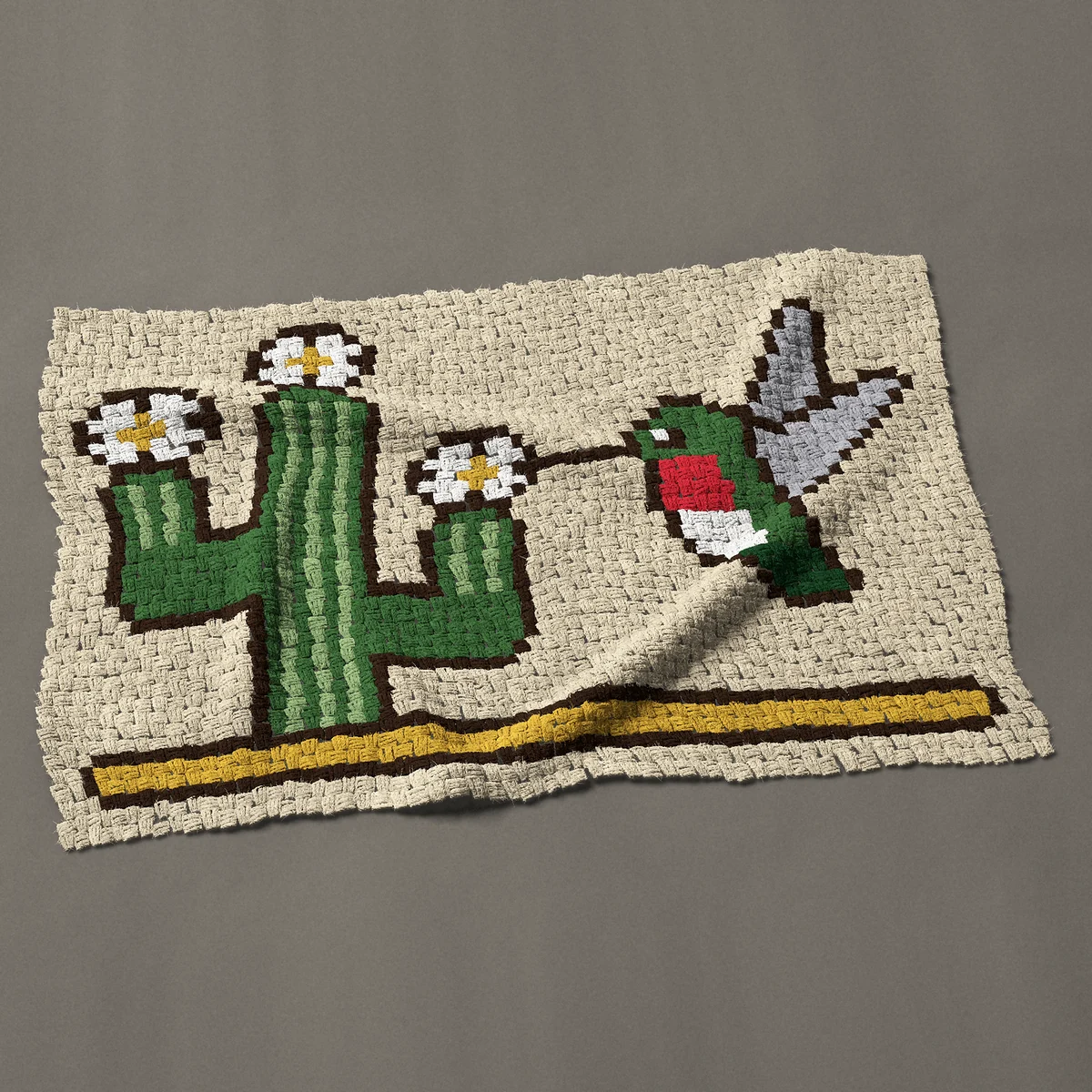 A baby blanket worked corner to corner, 47 by 32¼ inches: Hummingbird at a saguaro cactus in bloom, 63 by 43 blocks