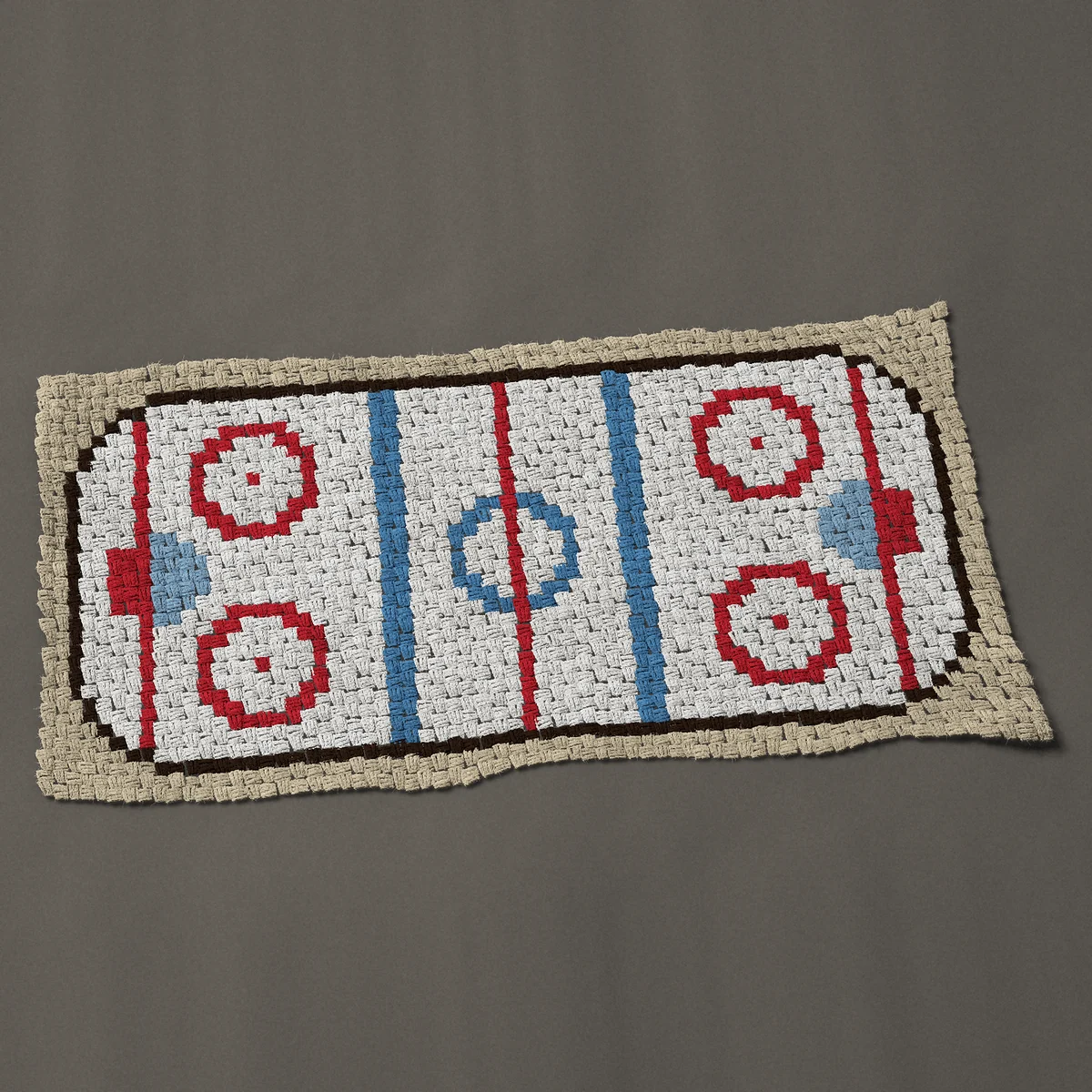 A baby blanket worked corner to corner, 50 by 24¾ inches: Ice hockey rink from above with red and blue lines, 67 by 33 blocks
