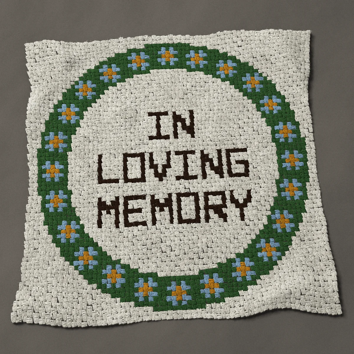 A throw worked corner to corner, 50 by 50 inches: In loving memory wreath of forget me not flowers, 67 by 67 blocks