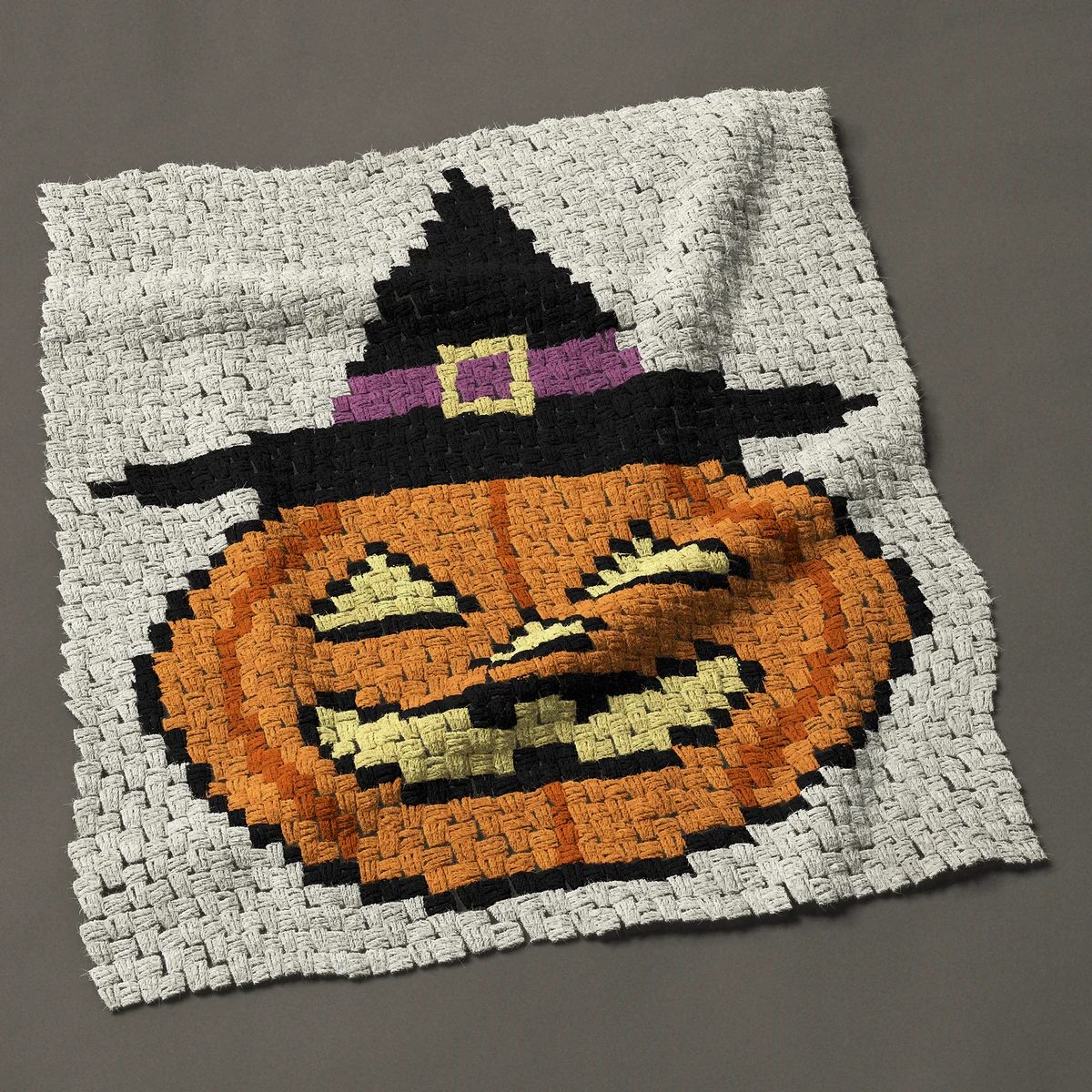 A baby blanket worked corner to corner, 33¾ by 38 inches: Jack o lantern pumpkin wearing a witch hat, 45 by 51 blocks