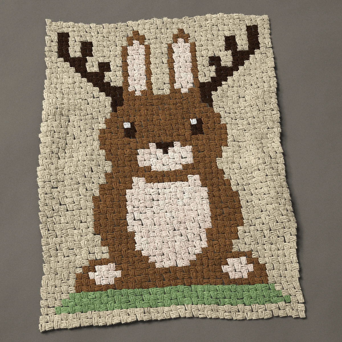 A baby blanket worked corner to corner, 29¼ by 39½ inches: Jackalope: a brown rabbit with antlers sitting up, 39 by 53 blocks