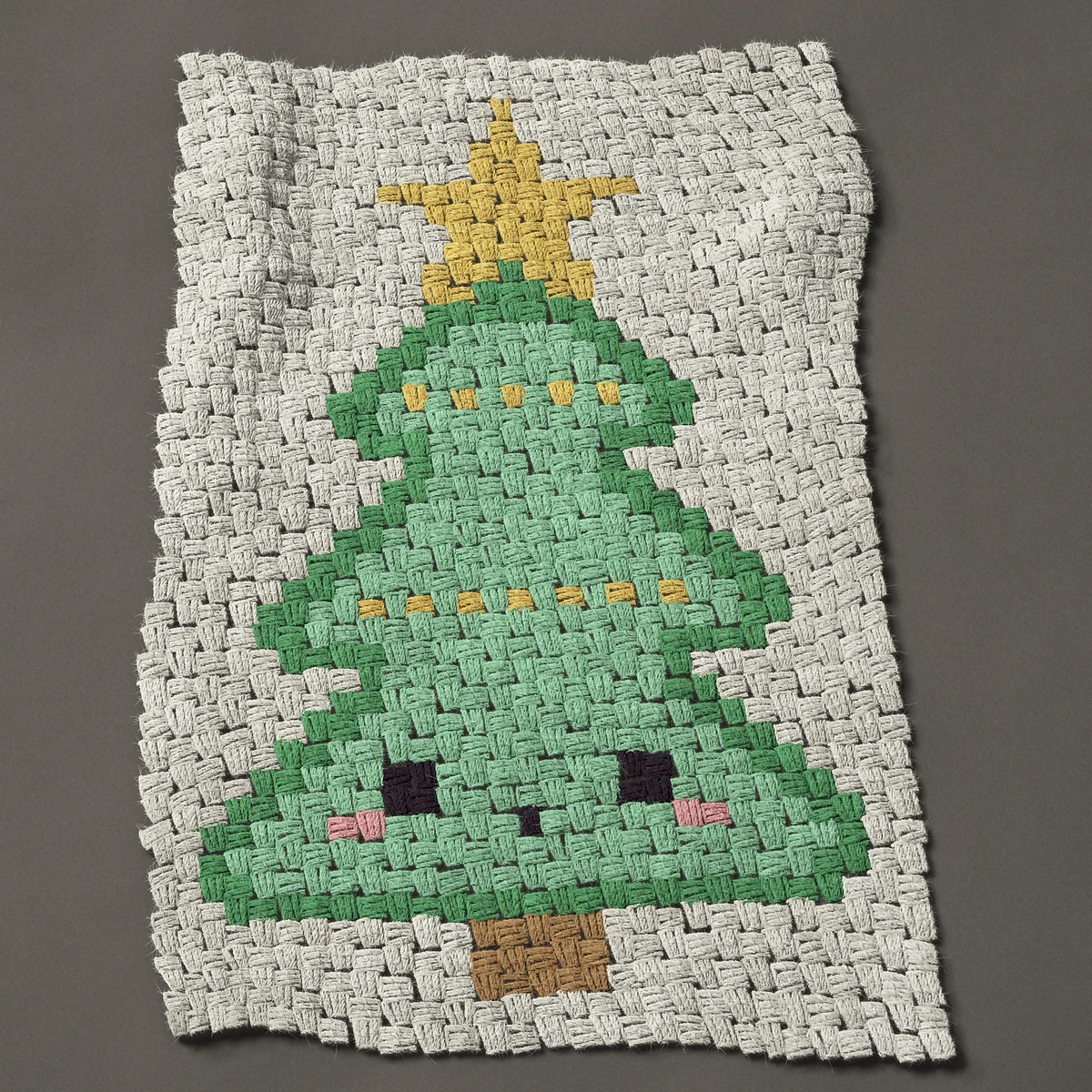 A panel worked corner to corner, 21¾ by 32¼ inches: Kawaii Christmas tree with a face and a star, 29 by 43 blocks
