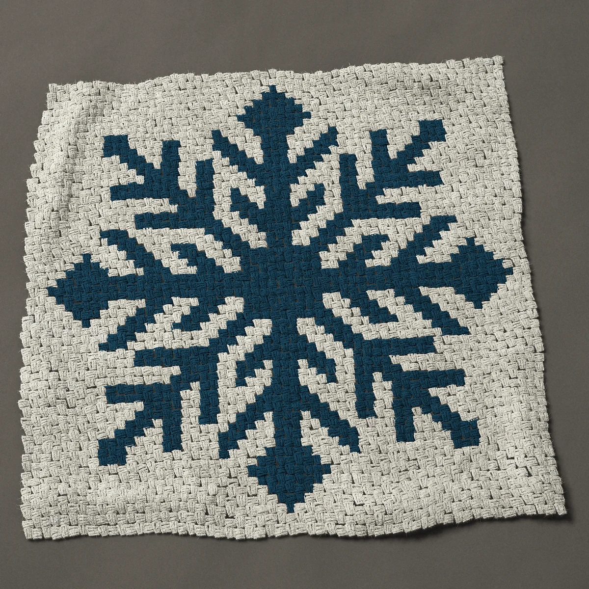 A panel worked corner to corner, 42½ by 42½ inches: Large blue snowflake with feathered arms, one color, 57 by 57 blocks