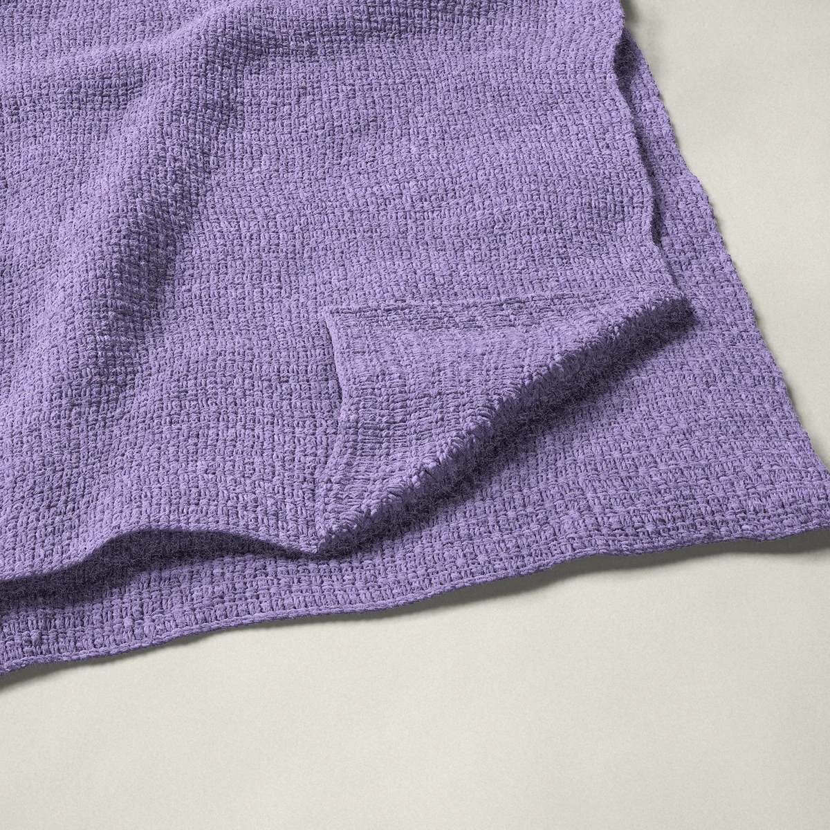 A throw in lemon peel stitch, 54¼ by 66¼ inches, folded in half with a corner turned back