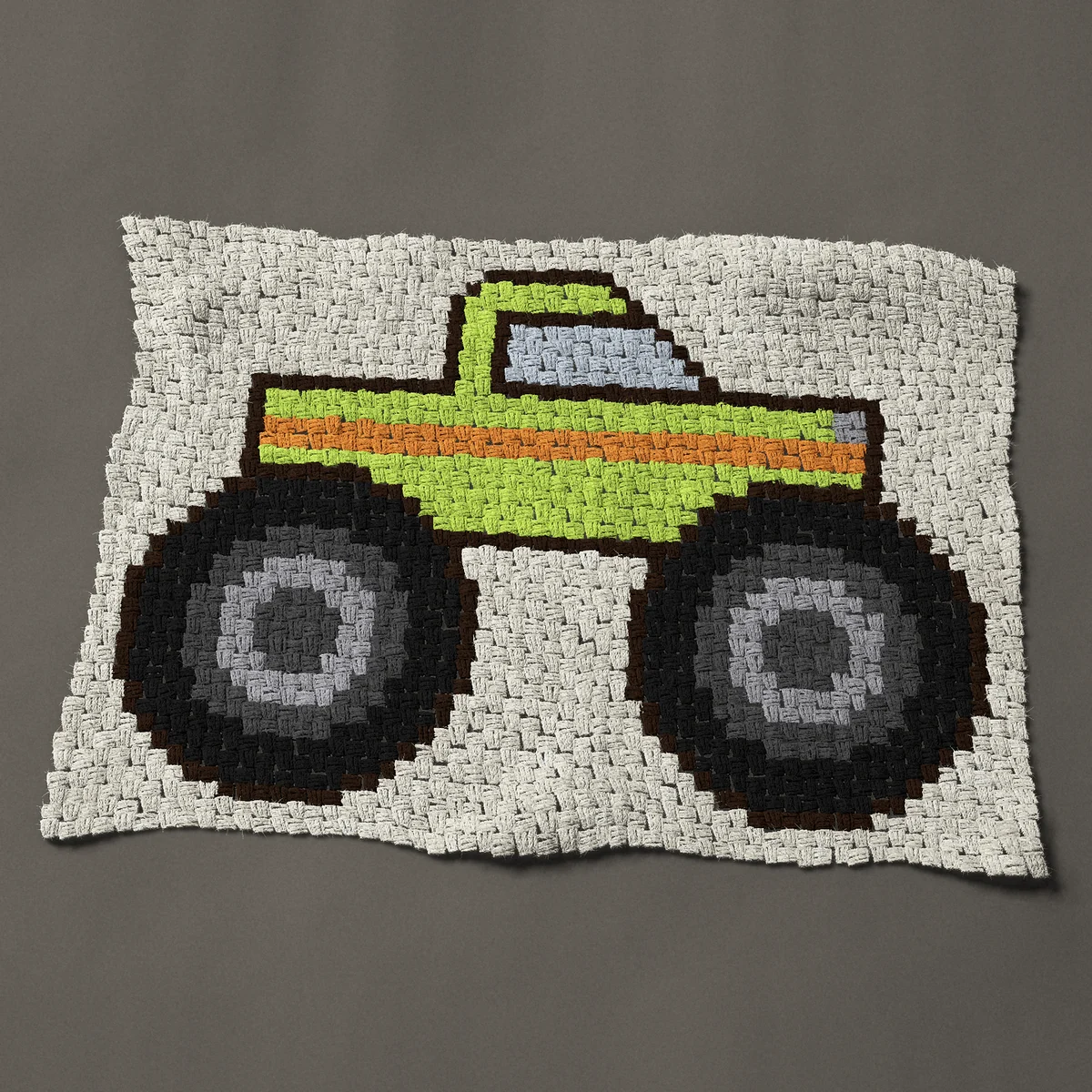 A baby blanket worked corner to corner, 41 by 29¼ inches: Lime green monster truck with giant black tires, 55 by 39 blocks