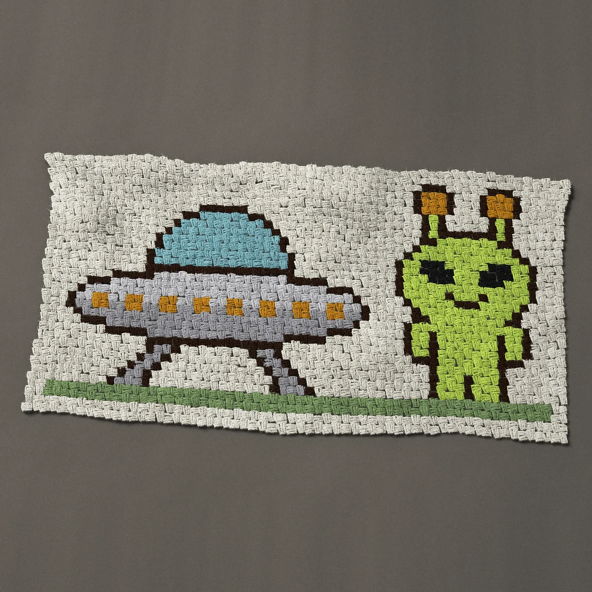 A baby blanket worked corner to corner, 46½ by 24¾ inches: Little green alien beside a landed UFO flying saucer, 62 by 33 blocks