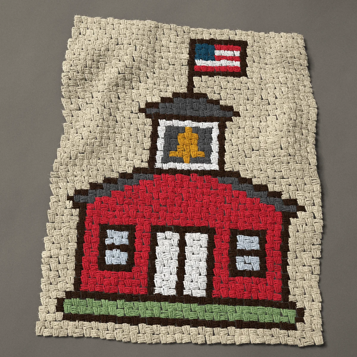 A baby blanket worked corner to corner, 27¾ by 37½ inches: Little red schoolhouse with a bell and a flag, 37 by 50 blocks