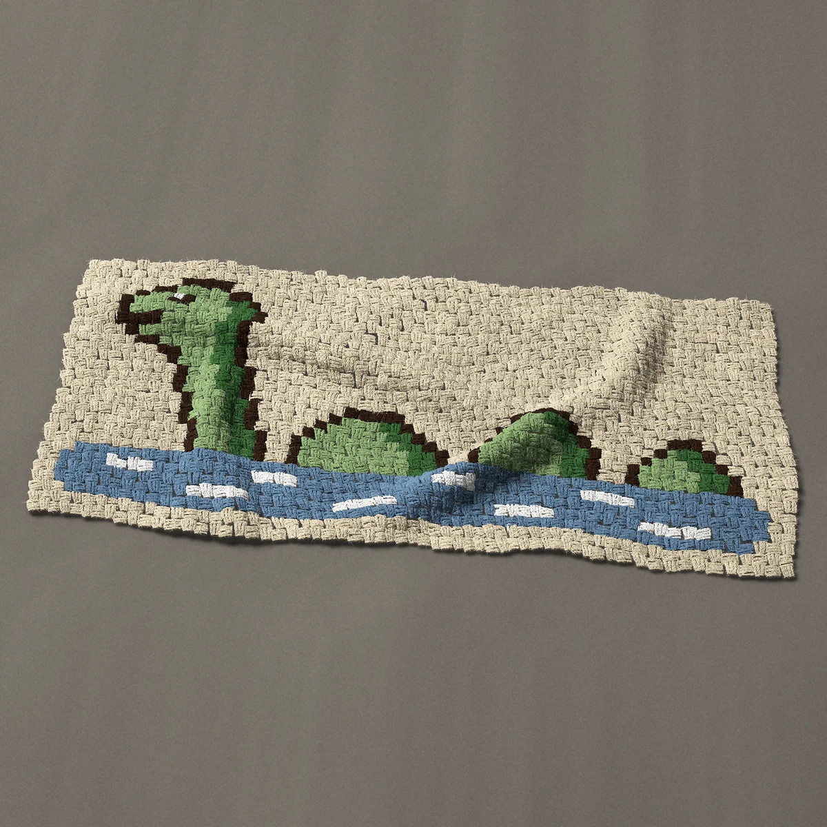 A panel worked corner to corner, 46½ by 21 inches: Loch Ness monster Nessie swimming with three humps, 62 by 28 blocks