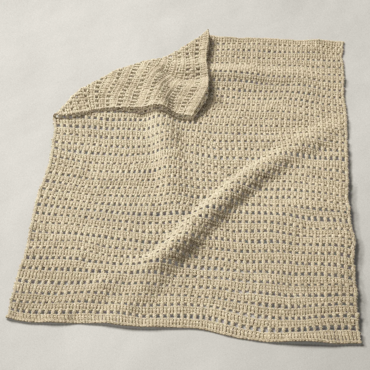 A baby blanket in mesh and double crochet rows, 32¼ by 40½ inches, spread out with a corner turned over