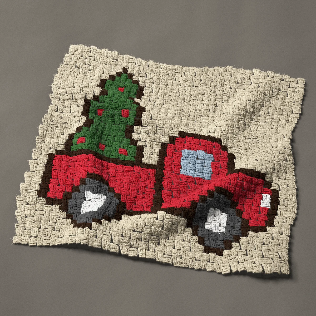 A panel worked corner to corner, 27 by 26¼ inches: Miniature red Christmas truck with a tree in the bed, 36 by 35 blocks