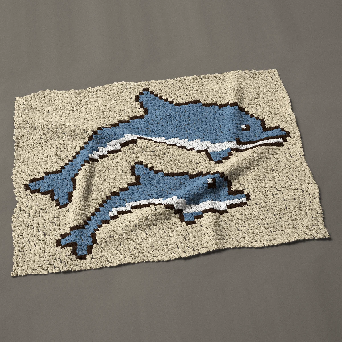 A lap blanket worked corner to corner, 49½ by 37½ inches: Mother dolphin and calf leaping together, 66 by 50 blocks