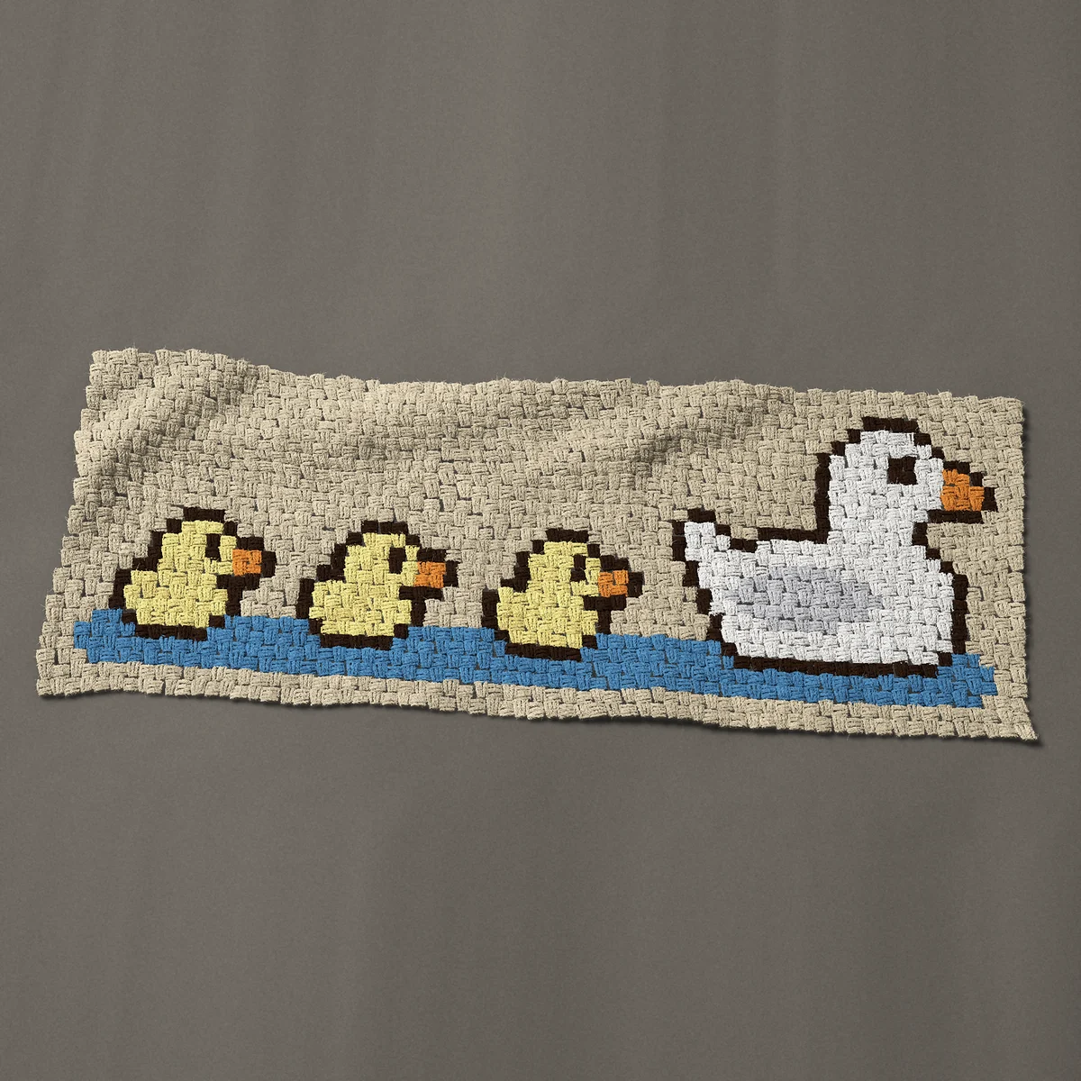 A panel worked corner to corner, 51 by 19½ inches: Mother duck and three ducklings, ducks in a row, 68 by 26 blocks