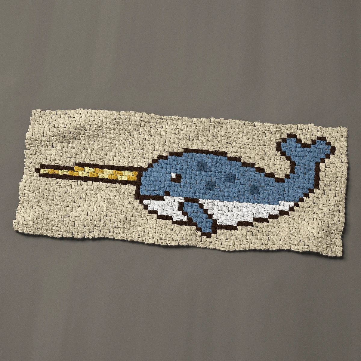 A panel worked corner to corner, 48½ by 21 inches: Narwhal with a spiral tusk and a smile, 65 by 28 blocks