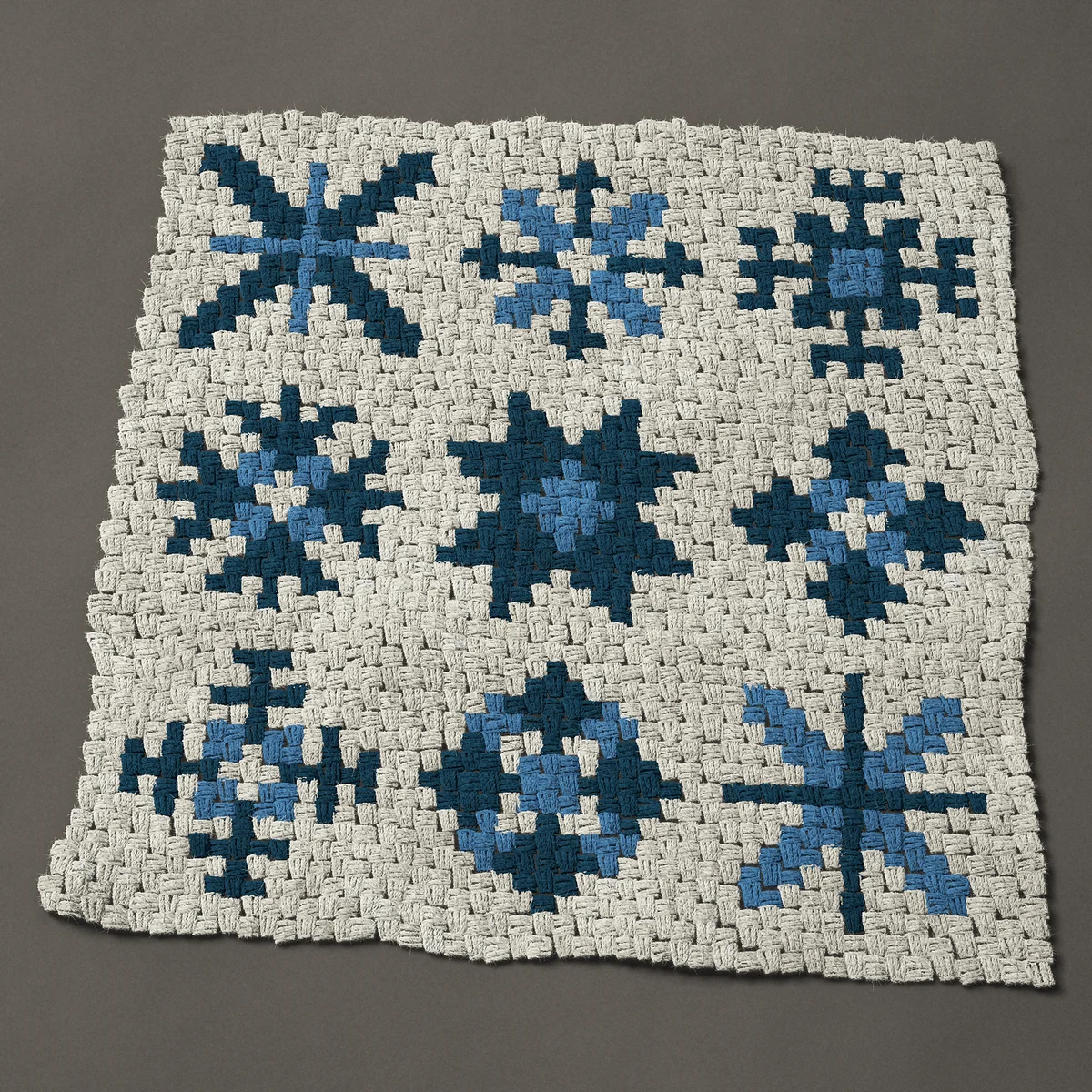 A panel worked corner to corner, 35¼ by 35¼ inches: Nine snowflakes in two shades of blue, 47 by 47 blocks