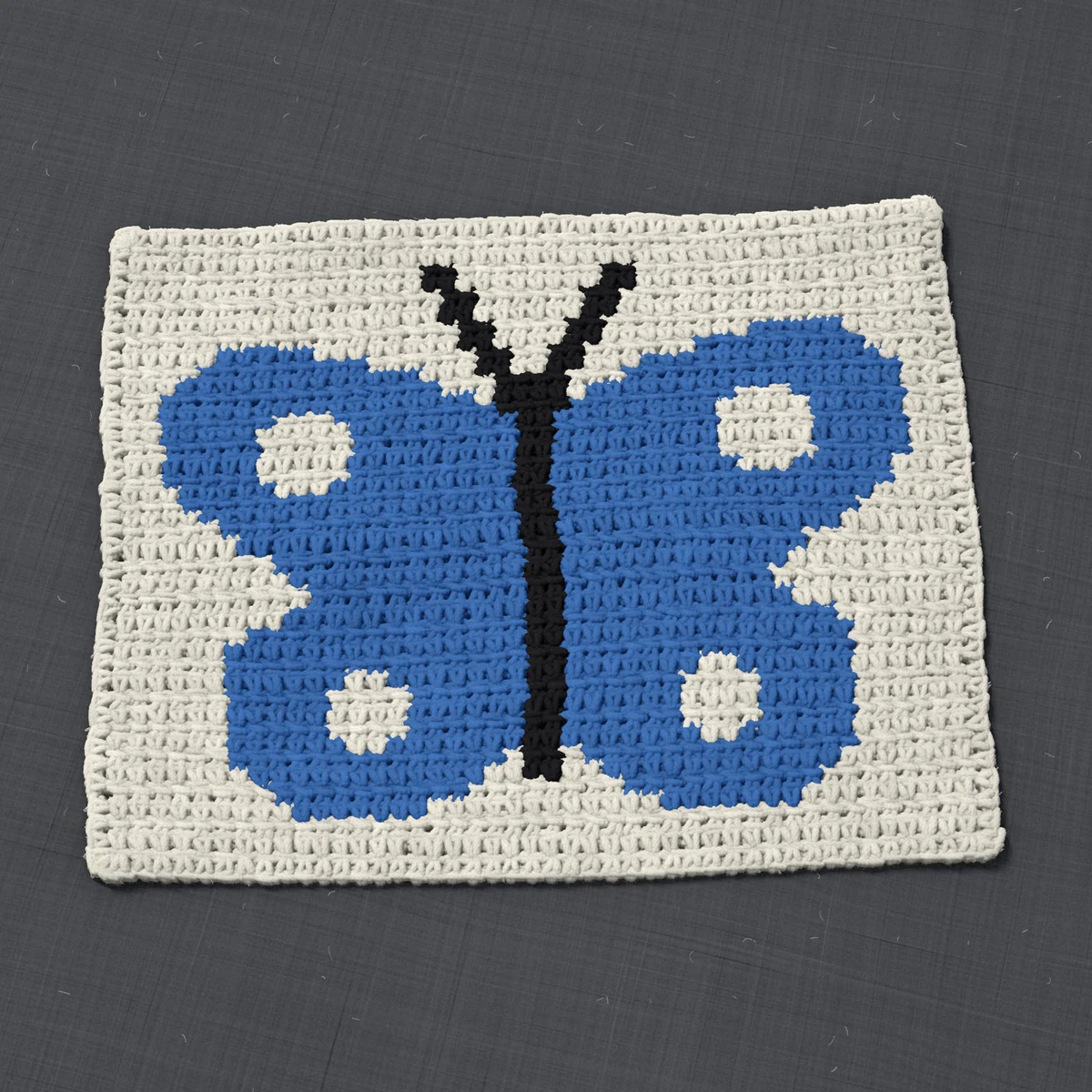 A panel in single crochet, 13.5 by 10.7 inches: a butterfly in blue and black on a cream ground, 44 stitches by 40 rows