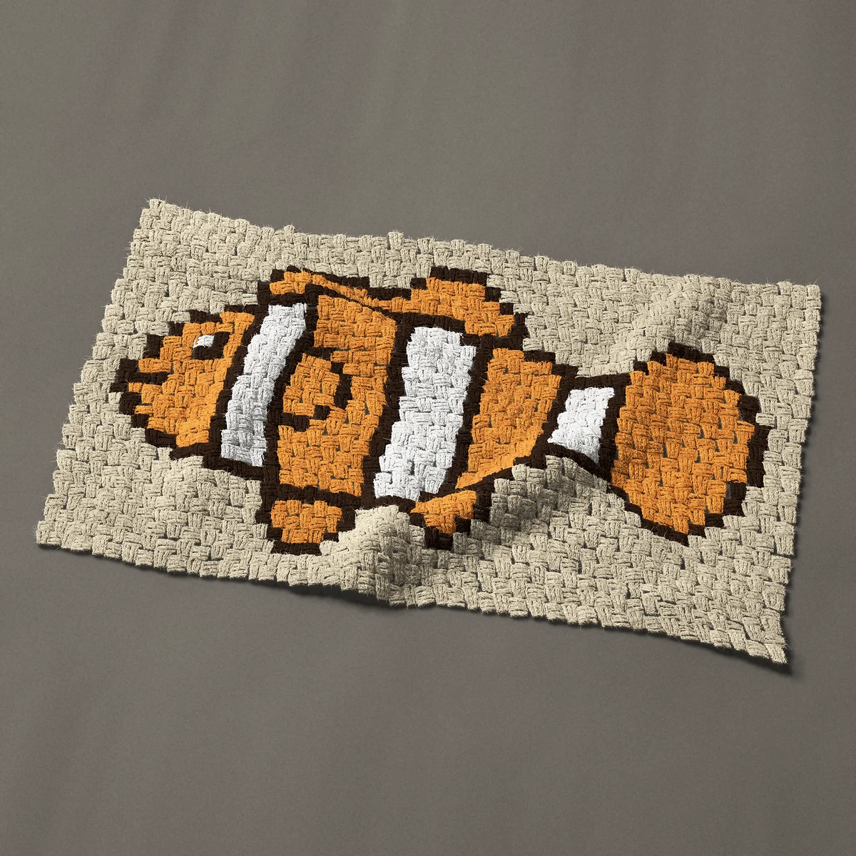 A panel worked corner to corner, 35¼ by 21¾ inches: Orange clownfish, a tropical fish with white bands, 47 by 29 blocks