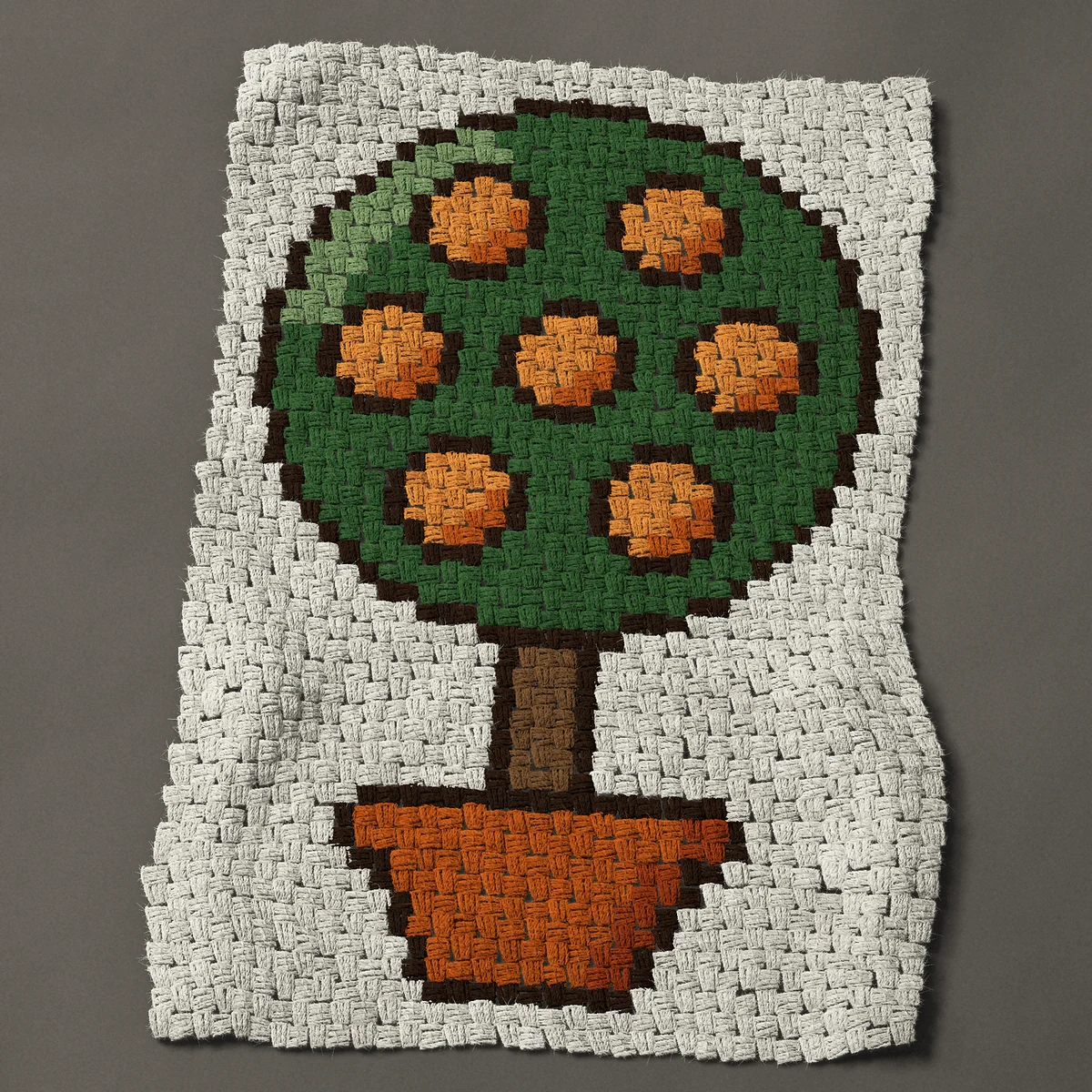 A baby blanket worked corner to corner, 26¼ by 39 inches: Orange tree in a terracotta pot with seven oranges, 35 by 52 blocks