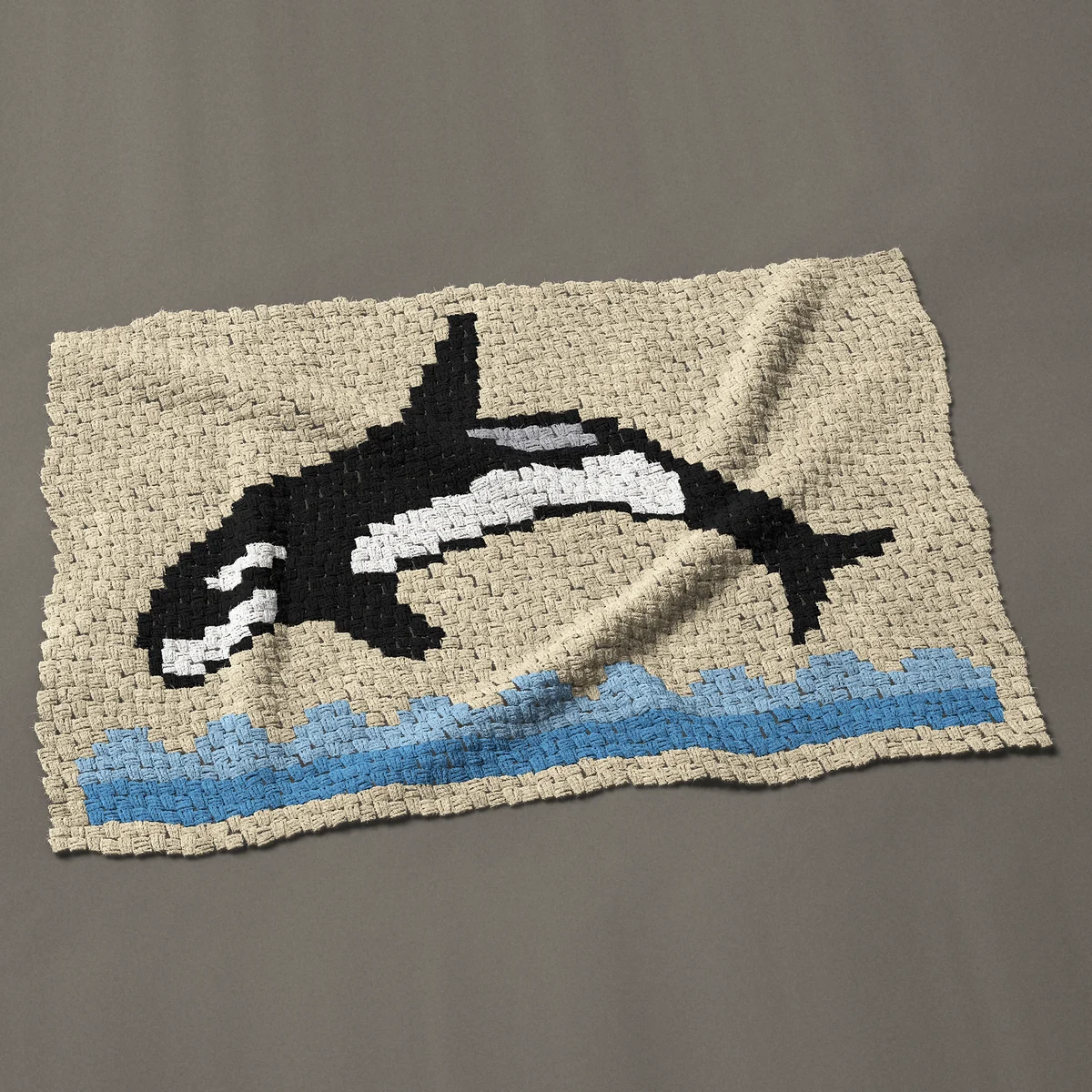 A baby blanket worked corner to corner, 50 by 33¾ inches: Orca killer whale leaping over blue waves, 67 by 45 blocks