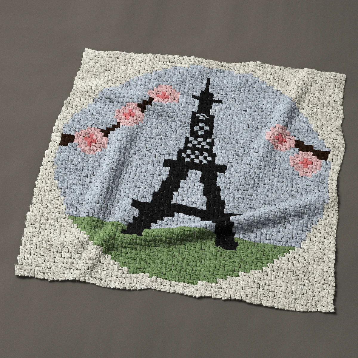 A panel worked corner to corner, 47 by 47 inches: Paris in spring: Eiffel Tower with cherry blossom, 63 by 63 blocks