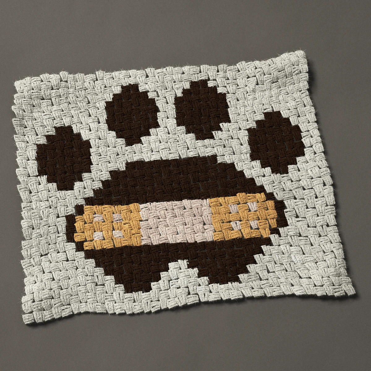 A panel worked corner to corner, 25½ by 21¾ inches: Paw print with a bandage, a veterinarian motif, 34 by 29 blocks