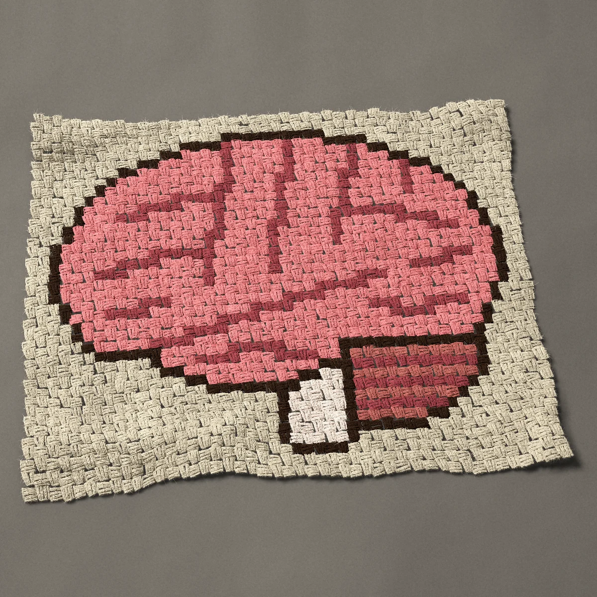 A panel worked corner to corner, 34½ by 28½ inches: Anatomical brain: pink human brain in side view, 46 by 38 blocks