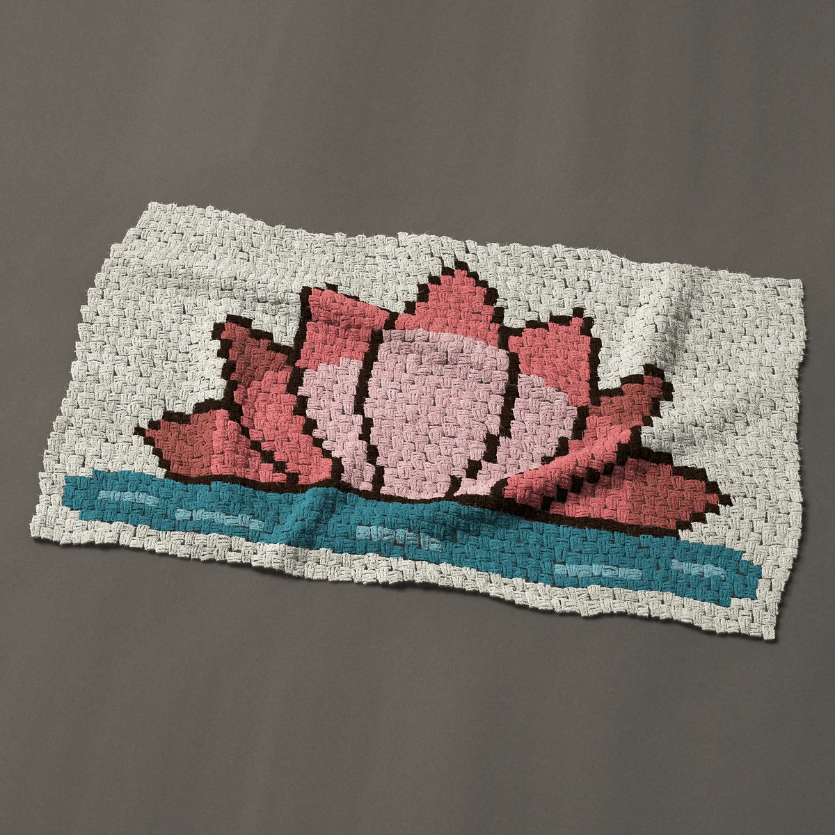 A baby blanket worked corner to corner, 47 by 27¾ inches: Pink lotus flower or water lily resting on the water, 63 by 37 blocks
