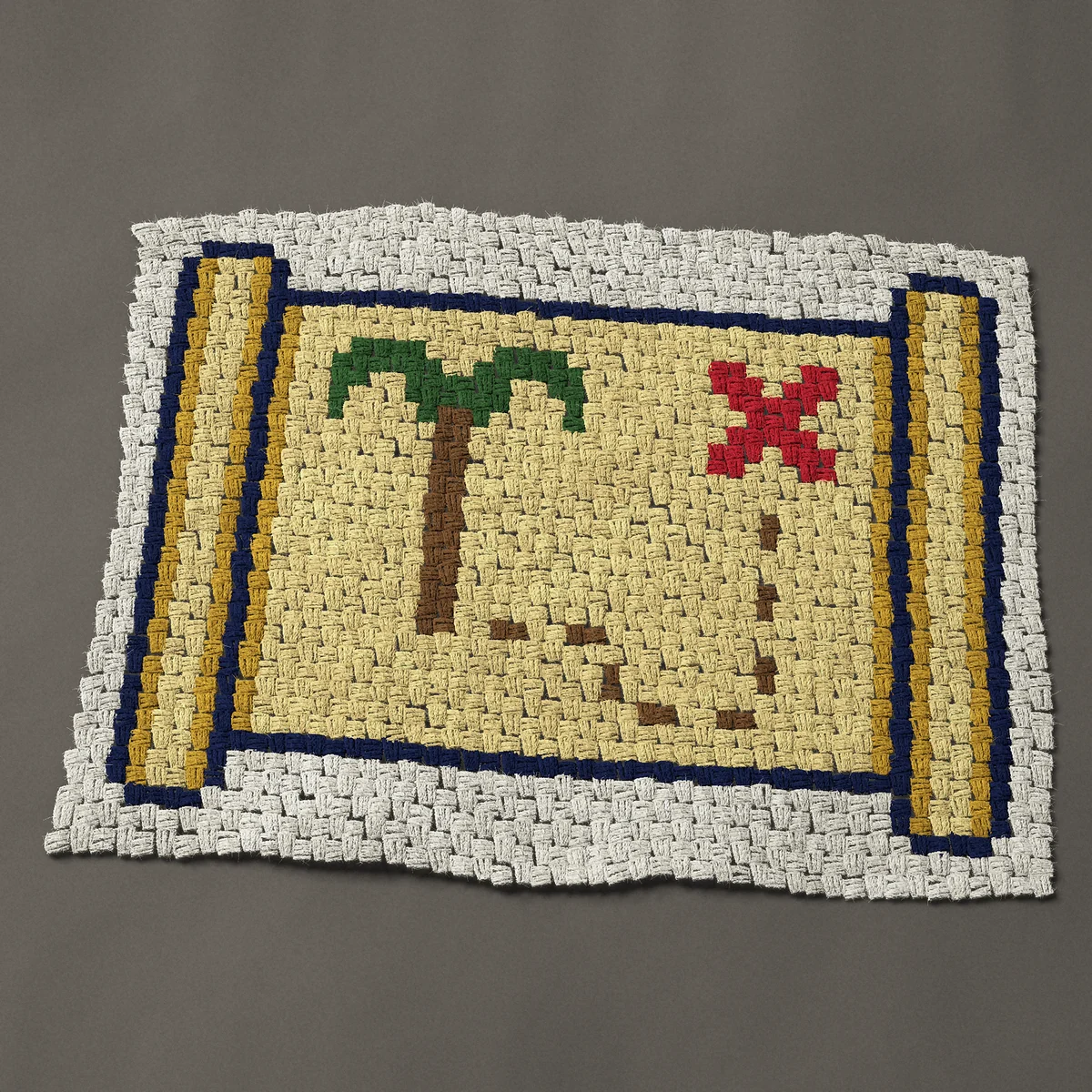 A baby blanket worked corner to corner, 37½ by 27¾ inches: Pirate treasure map scroll with a palm tree and red X, 50 by 37 blocks