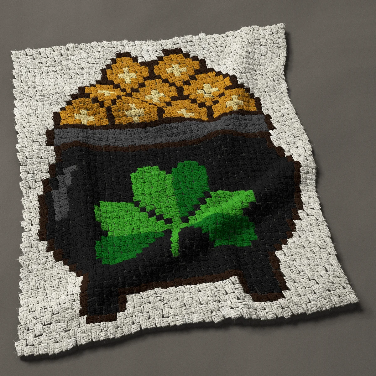 A baby blanket worked corner to corner, 32¼ by 39½ inches: Pot of gold with a shamrock for St Patrick's Day, 43 by 53 blocks