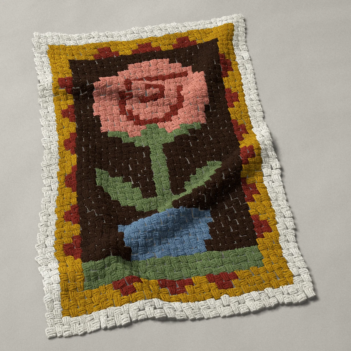 A baby blanket worked corner to corner, 25½ by 39 inches: Primitive folk rose in a blue flower pot, 34 by 52 blocks