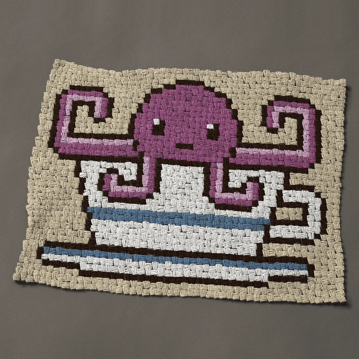 A baby blanket worked corner to corner, 37½ by 29¼ inches: Purple octopus in a teacup, 50 by 39 blocks