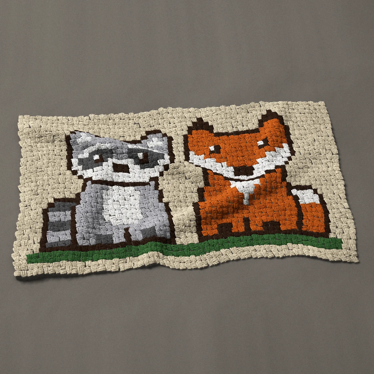A baby blanket worked corner to corner, 45 by 26¼ inches: Raccoon and fox sitting side by side, woodland friends, 60 by 35 blocks