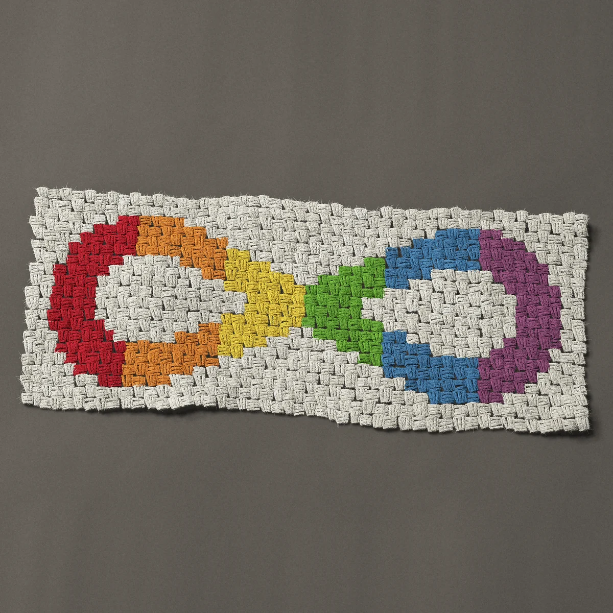 A panel worked corner to corner, 36 by 15 inches: Rainbow infinity symbol for autism and neurodiversity, 48 by 20 blocks