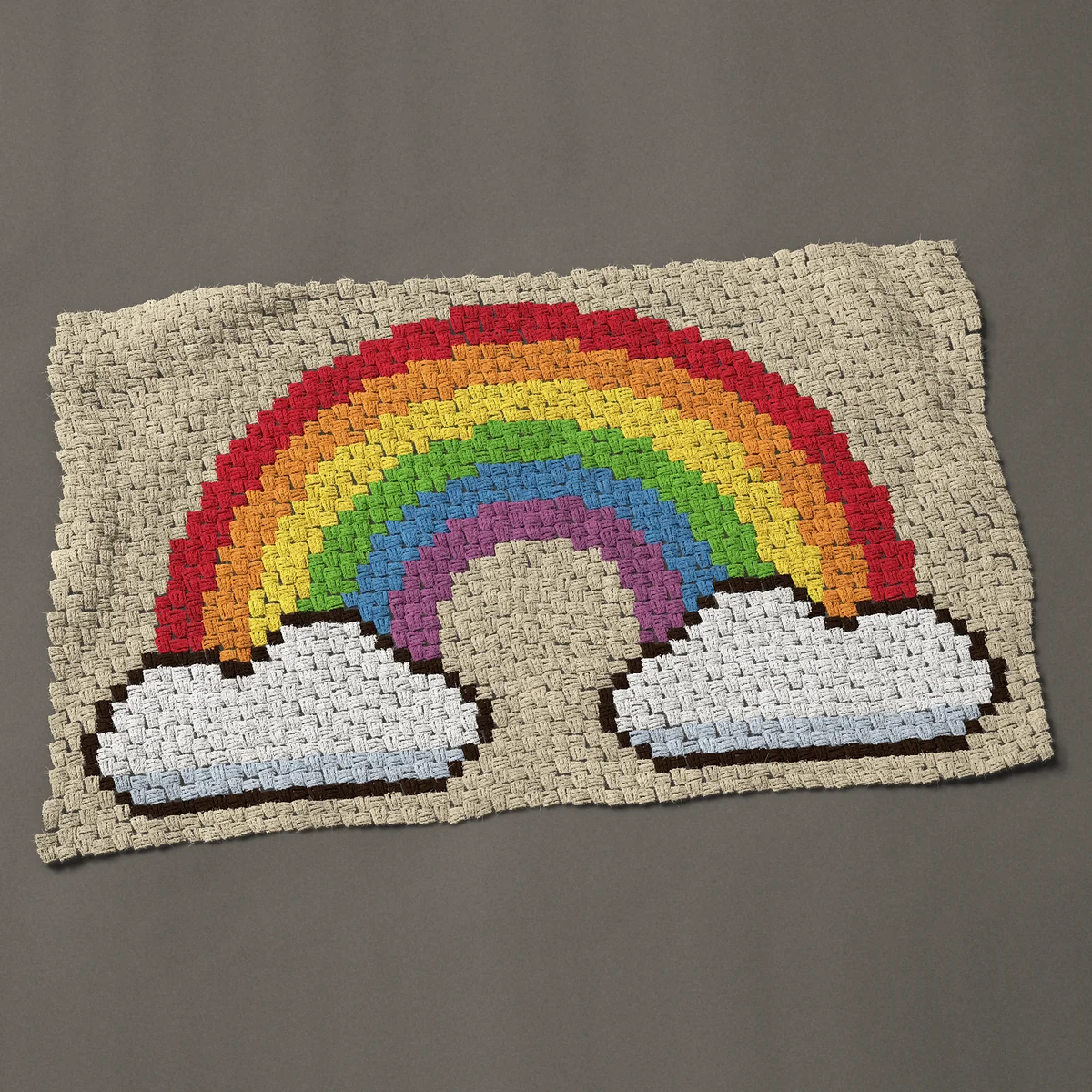 A baby blanket worked corner to corner, 47 by 29¼ inches: Rainbow with clouds, a white cloud at each end, 63 by 39 blocks