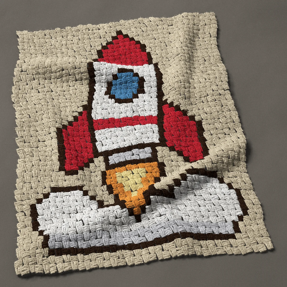 A baby blanket worked corner to corner, 27¾ by 37½ inches: Red and white space rocket ship lifting off, 37 by 50 blocks