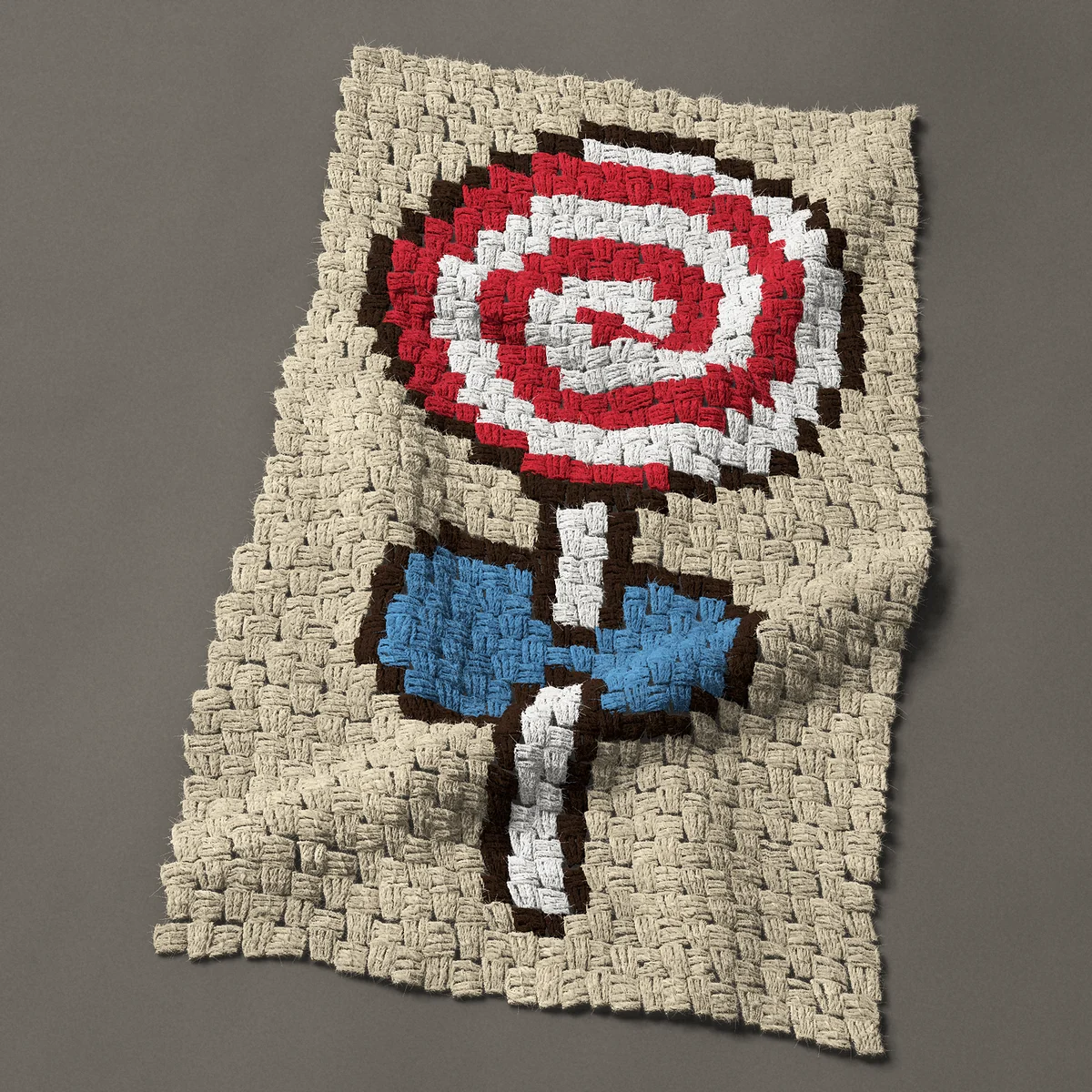 A panel worked corner to corner, 19½ by 33¾ inches: Red and white swirl lollipop with a blue bow, 26 by 45 blocks