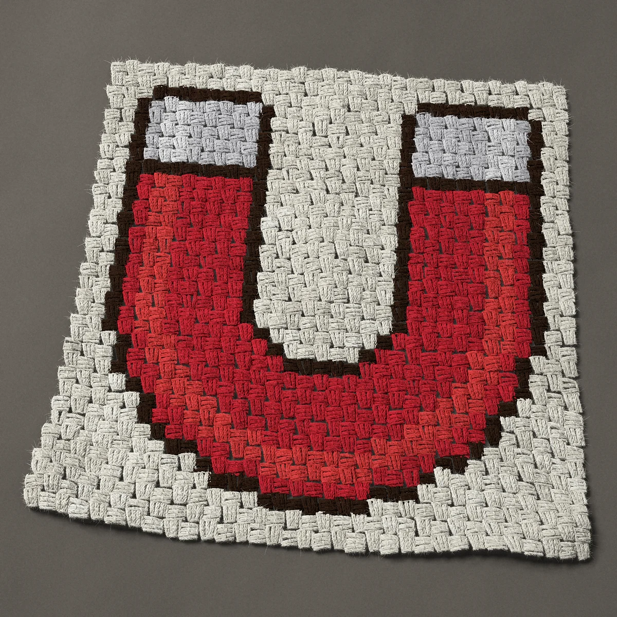 A panel worked corner to corner, 24¾ by 25½ inches: Red horseshoe magnet with silver poles, 33 by 34 blocks