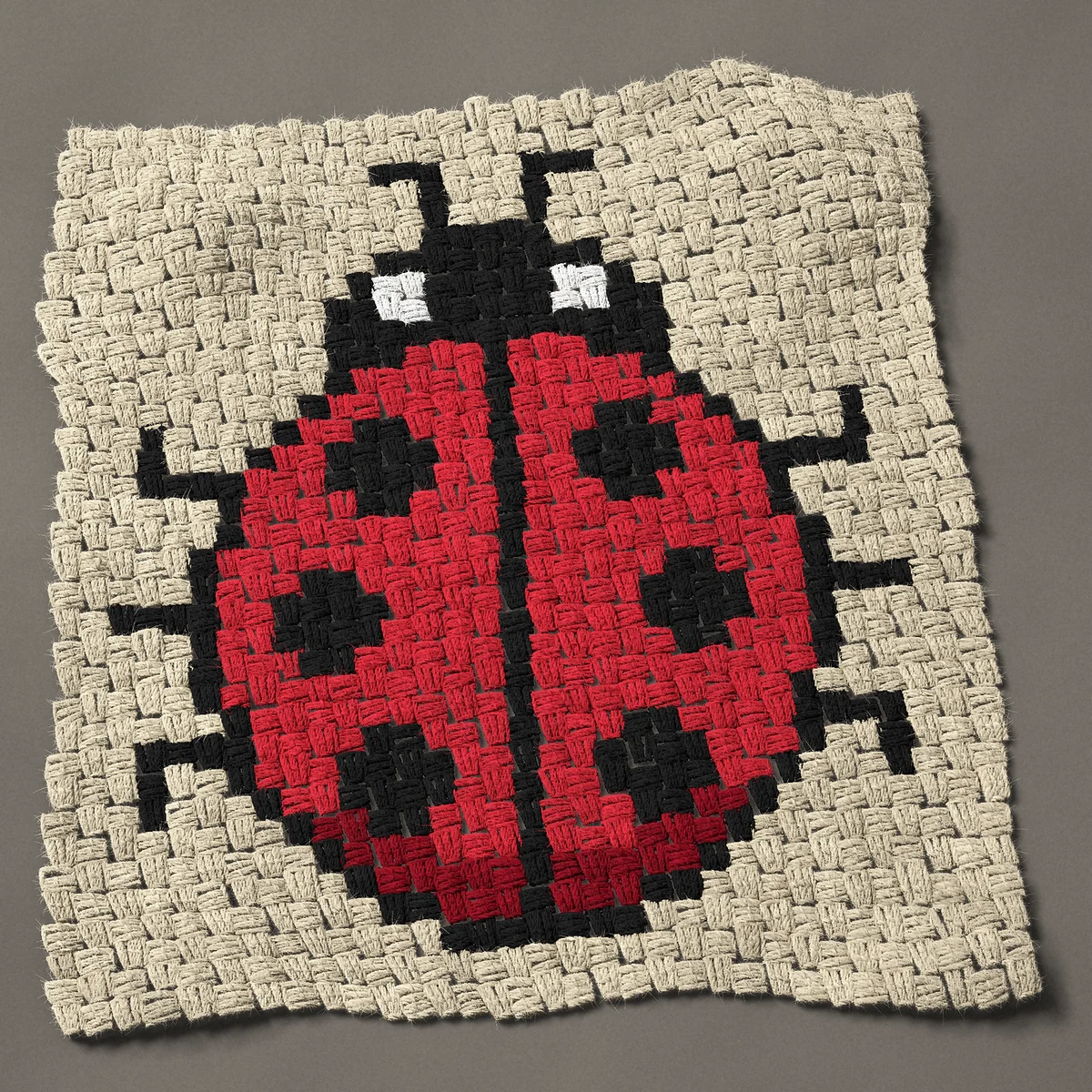 A panel worked corner to corner, 24¾ by 26¼ inches: Red ladybug from above with six black spots, 33 by 35 blocks