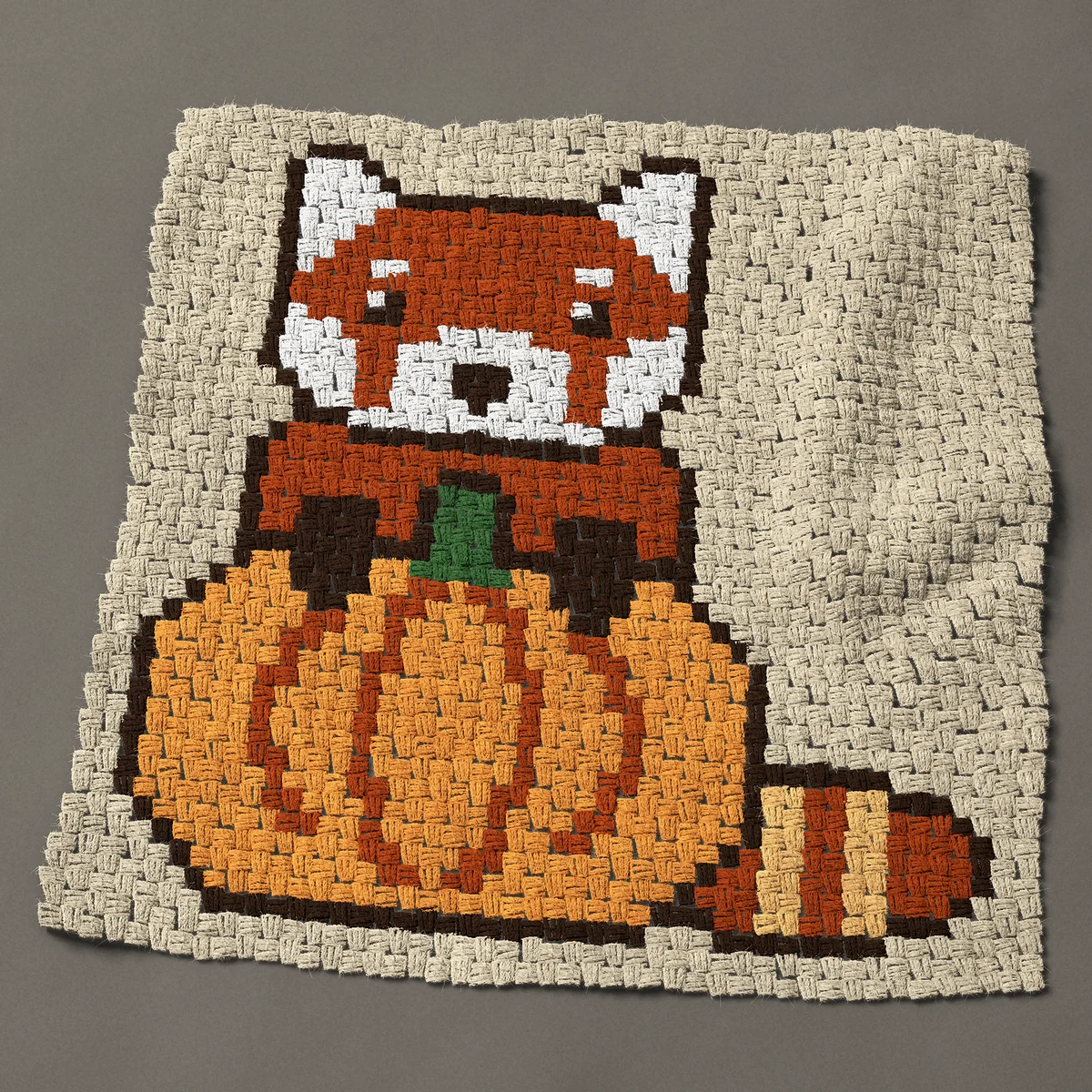A panel worked corner to corner, 34½ by 34½ inches: Red panda with both paws on a pumpkin, 46 by 46 blocks