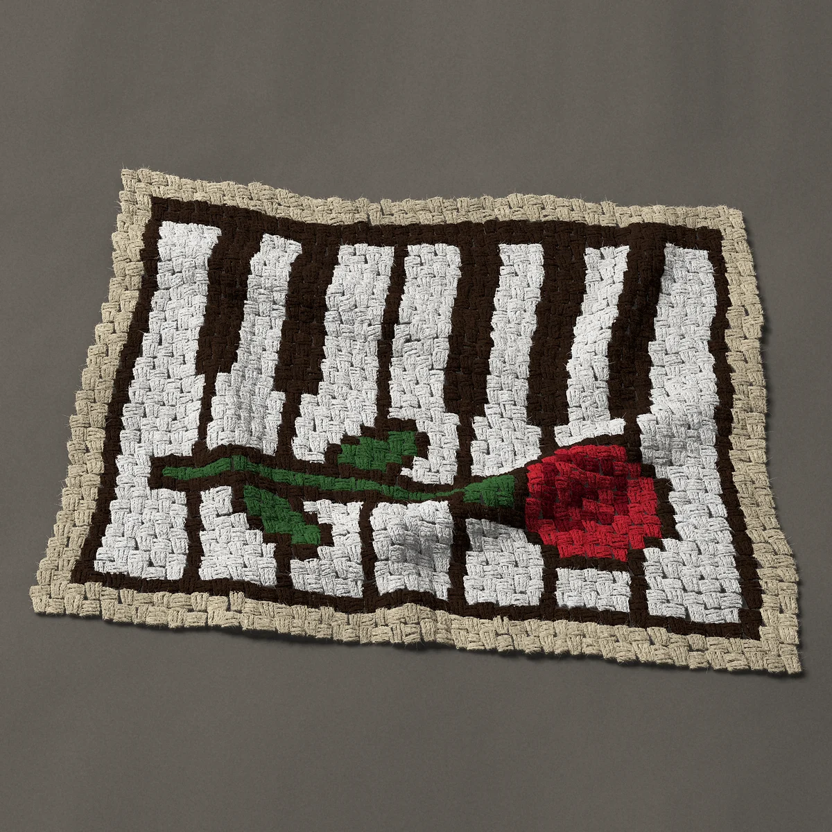 A panel worked corner to corner, 35¼ by 28½ inches: Red rose on piano keys, 47 by 38 blocks