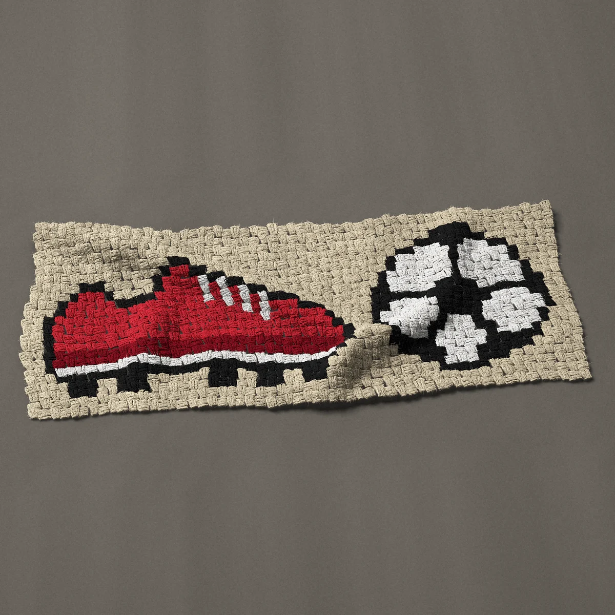 A panel worked corner to corner, 42½ by 17¼ inches: Red soccer cleat and soccer ball, 57 by 23 blocks