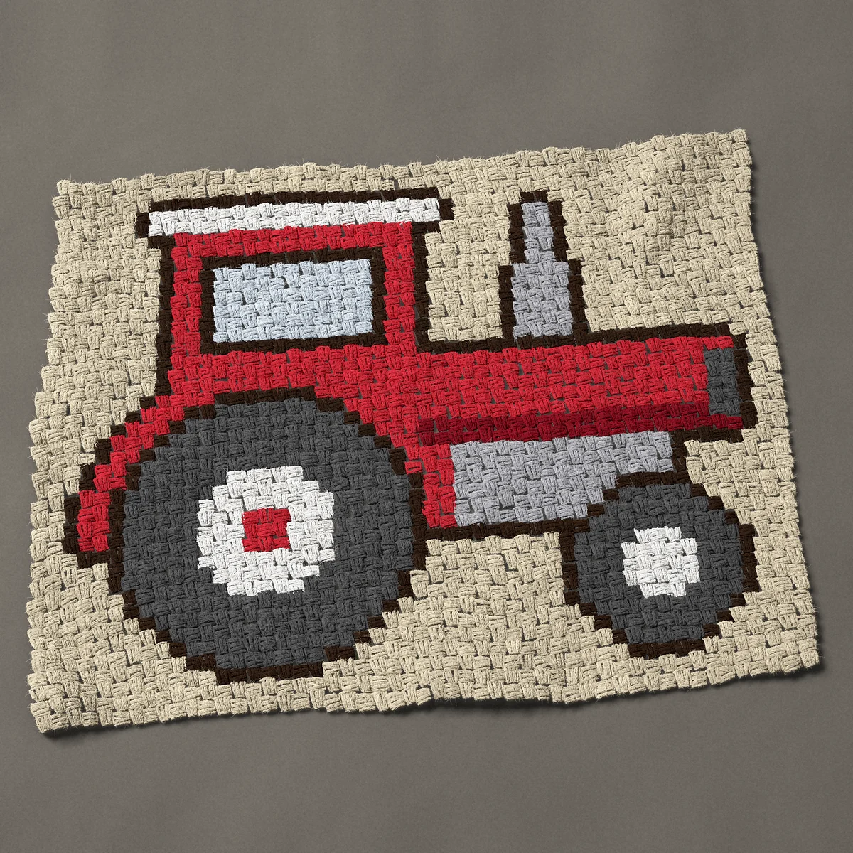 A baby blanket worked corner to corner, 38 by 30¾ inches: Red farm tractor in side view with a tall exhaust, 51 by 41 blocks