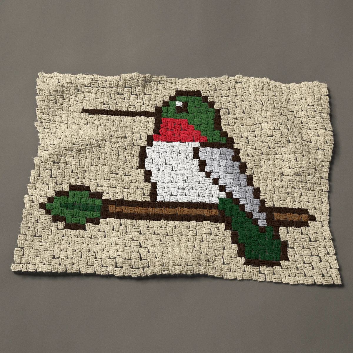 A panel worked corner to corner, 33 by 24 inches: Ruby-throated hummingbird perched on a twig, 44 by 32 blocks