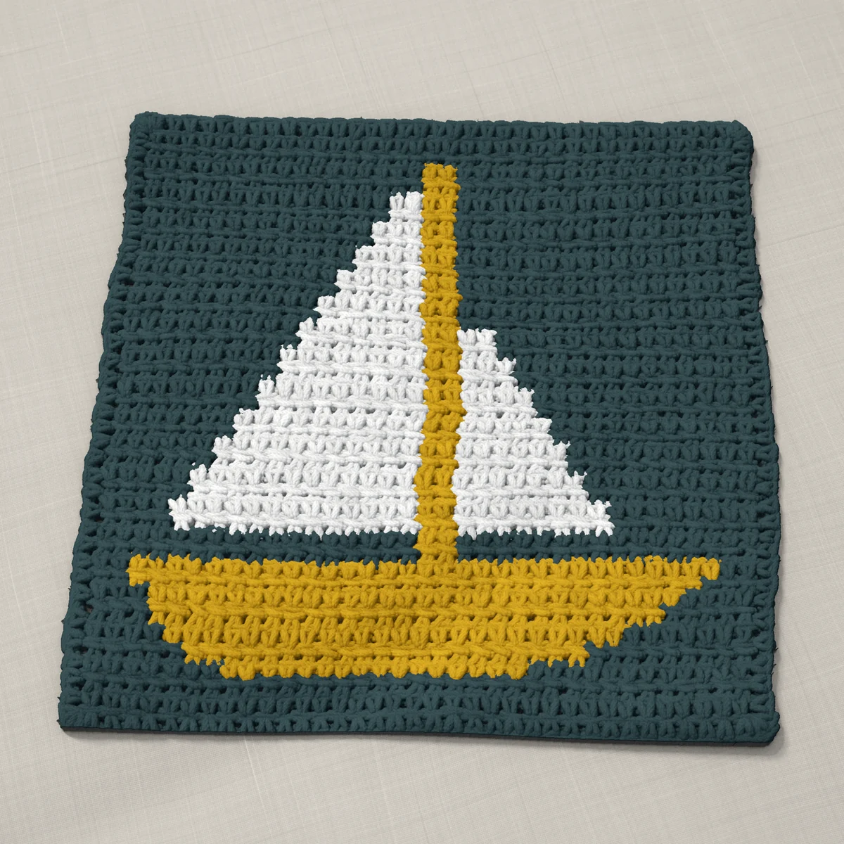 A washcloth in single crochet, 10.8 by 10.4 inches: a sailboat in white and gold on a slate gray ground, 35 stitches by 39 rows