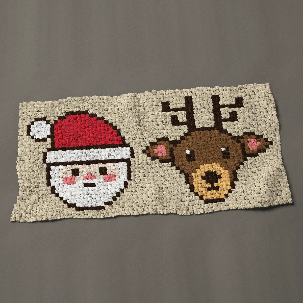 A baby blanket worked corner to corner, 49½ by 24¾ inches: Santa and reindeer faces side by side, 66 by 33 blocks