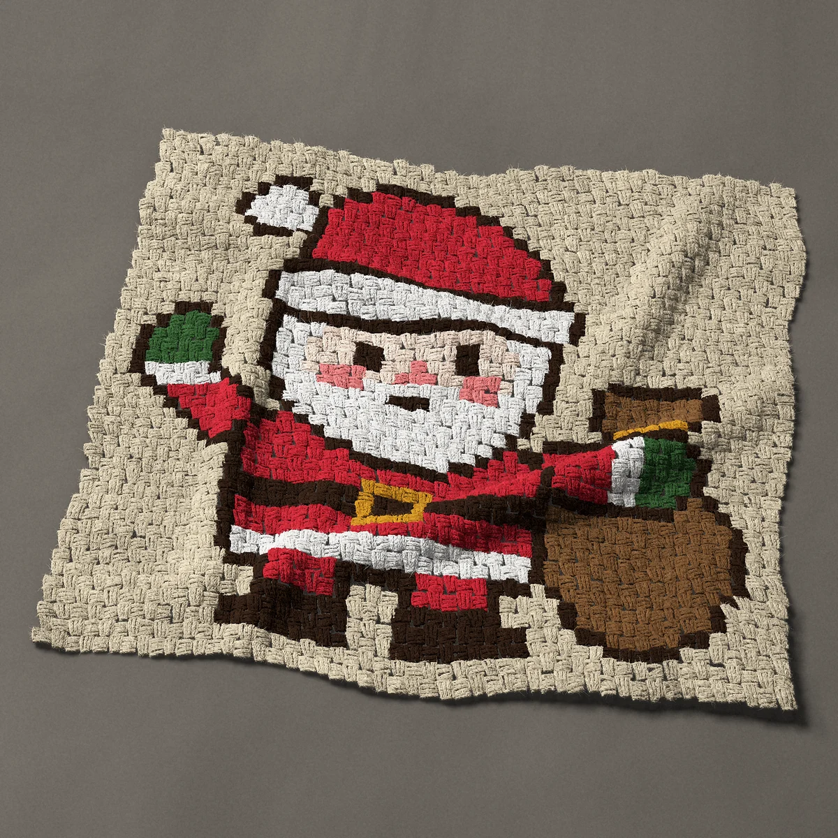 A baby blanket worked corner to corner, 37½ by 33 inches: Santa Claus waving beside his sack, 50 by 44 blocks