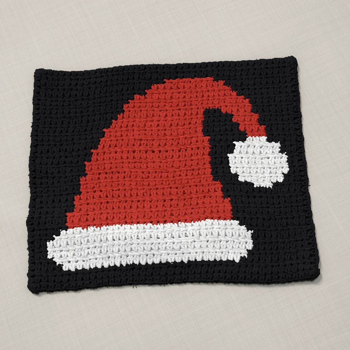 A panel in single crochet, 12.9 by 10.7 inches: a Santa hat in red and white on a black ground, 42 stitches by 40 rows