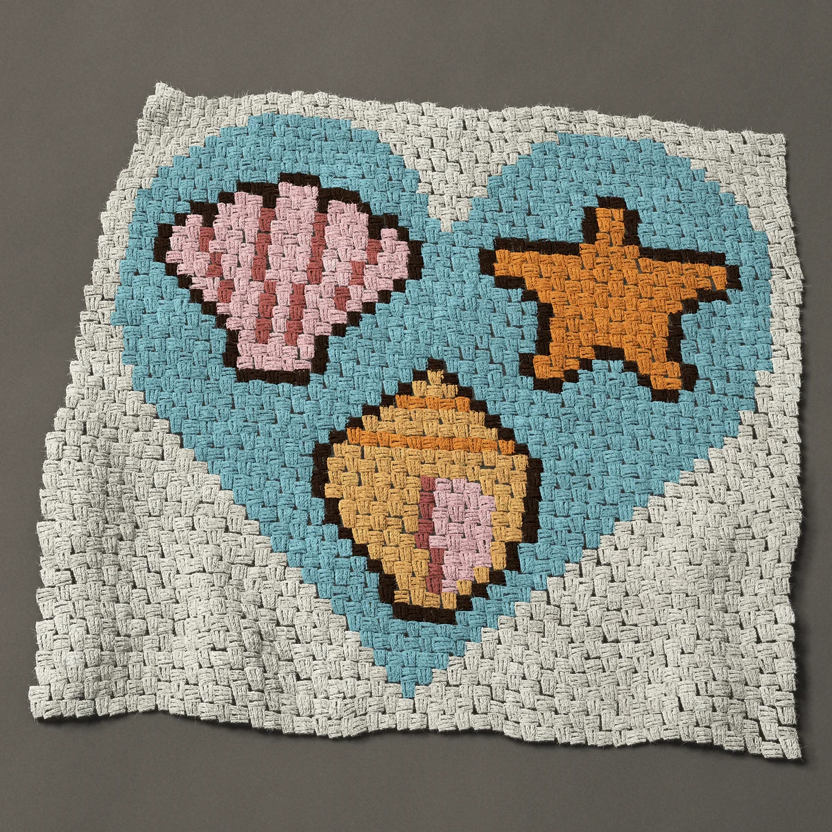 A baby blanket worked corner to corner, 36¾ by 35¼ inches: Seashell heart: scallop, starfish and spiral shell, 49 by 47 blocks
